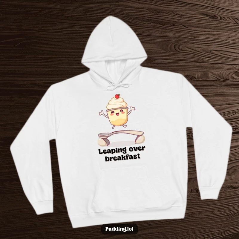 Funny hoodie: A pudding cup character enthusiastically jumps over a spoon bridge, offering warmth and a good dose of dessert humor.